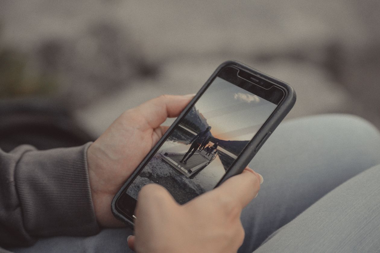 A hand holding a smartphone.